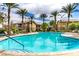 A refreshing community pool surrounded by tall palm trees and lounge chairs provides a relaxing outdoor retreat at 6868 Sky Pointe Dr # 1122, Las Vegas, NV 89131