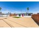 Rear exterior view of home featuring a sand yard and an artificial grass accent at 709 Rossmoyne Ave, North Las Vegas, NV 89030