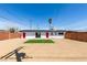 Spacious backyard with a patch of green grass and desert landscaping at 709 Rossmoyne Ave, North Las Vegas, NV 89030