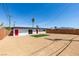 Rear exterior view of home featuring a sand yard and an artificial grass accent at 709 Rossmoyne Ave, North Las Vegas, NV 89030