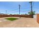 Spacious backyard featuring low maintenance desert landscaping and a small patch of green grass at 709 Rossmoyne Ave, North Las Vegas, NV 89030