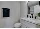 Bathroom boasts modern vanity with black faucet and towel, plus tiled shower at 709 Rossmoyne Ave, North Las Vegas, NV 89030