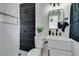 Stylish bathroom with white marble tile, a modern black shower, and updated fixtures at 709 Rossmoyne Ave, North Las Vegas, NV 89030