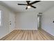 This bedroom features wood floors, a ceiling fan, and neutral walls at 709 Rossmoyne Ave, North Las Vegas, NV 89030