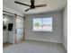 Bedroom boasts a barn door, a modern ceiling fan, and a window providing natural light at 709 Rossmoyne Ave, North Las Vegas, NV 89030
