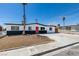 Charming single-story home showcasing a red front door, desert landscaping, and mature palm tree at 709 Rossmoyne Ave, North Las Vegas, NV 89030