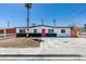 Charming single-story home showcasing a red front door, desert landscaping, and mature palm tree at 709 Rossmoyne Ave, North Las Vegas, NV 89030