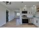 Bright kitchen featuring stainless steel appliances and white cabinets at 709 Rossmoyne Ave, North Las Vegas, NV 89030
