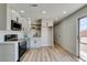 Updated kitchen featuring stainless steel appliances, modern white cabinets, and light wood flooring at 709 Rossmoyne Ave, North Las Vegas, NV 89030