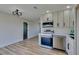 Bright kitchen featuring stainless steel appliances and white cabinets at 709 Rossmoyne Ave, North Las Vegas, NV 89030
