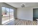 Bright living room featuring hardwood floors and sliding glass doors to the backyard at 709 Rossmoyne Ave, North Las Vegas, NV 89030