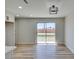 Open living room featuring wood floors and modern lighting fixture at 709 Rossmoyne Ave, North Las Vegas, NV 89030
