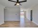 Spacious living room with wood floors, neutral walls, and modern ceiling fan at 709 Rossmoyne Ave, North Las Vegas, NV 89030