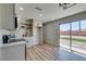 Open living room featuring wood floors and modern lighting fixture at 709 Rossmoyne Ave, North Las Vegas, NV 89030