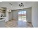 Open living room featuring wood floors and modern lighting fixture at 709 Rossmoyne Ave, North Las Vegas, NV 89030