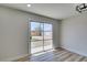Bright living room featuring hardwood floors and sliding glass doors to the backyard at 709 Rossmoyne Ave, North Las Vegas, NV 89030