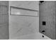 Newly remodeled shower with gray and white tile and a built-in shower niche at 709 Rossmoyne Ave, North Las Vegas, NV 89030