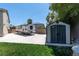 Backyard features an RV parked on concrete, a storage shed, and mature landscaping providing privacy at 7360 Dolphine Crest Ave, Las Vegas, NV 89129