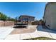 Home features a large backyard with a trampoline, potential garden area, and walkway to side yard at 7360 Dolphine Crest Ave, Las Vegas, NV 89129
