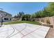 Spacious backyard with a basketball court, shed, and well-maintained landscaping at 7360 Dolphine Crest Ave, Las Vegas, NV 89129