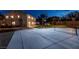 Night view of backyard with sports court for basketball and pickleball, lush lawn, and exterior home view at 7360 Dolphine Crest Ave, Las Vegas, NV 89129