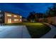 Night view of a home with a backyard basketball court and well-manicured lawn with a shed in the background at 7360 Dolphine Crest Ave, Las Vegas, NV 89129
