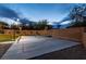 Backyard featuring a lighted basketball court with multiple hoops, set against a mature landscaped backdrop at 7360 Dolphine Crest Ave, Las Vegas, NV 89129