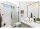 Modern bathroom features a glass-enclosed shower, white subway tile, and sleek vanity, providing a spa-like experience at 7360 Dolphine Crest Ave, Las Vegas, NV 89129