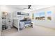 Well-lit bedroom with a bunk bed, white shiplap walls, and a view of the neighborhood at 7360 Dolphine Crest Ave, Las Vegas, NV 89129