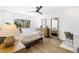Cozy bedroom with wood floors, a large window, and a stylish decor at 7360 Dolphine Crest Ave, Las Vegas, NV 89129