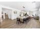 Open concept dining room featuring large table, hardwood flooring, and stylish decor at 7360 Dolphine Crest Ave, Las Vegas, NV 89129