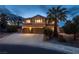 Beautiful two-story home with three-car garage, long driveway, and lush landscaping at 7360 Dolphine Crest Ave, Las Vegas, NV 89129