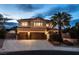 Stunning two-story home with a three-car garage, large driveway, manicured landscaping and a palm tree at 7360 Dolphine Crest Ave, Las Vegas, NV 89129