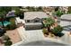 Two-story home featuring a three-car garage, mature landscaping, a pool, and RV parking at 7360 Dolphine Crest Ave, Las Vegas, NV 89129