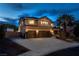 Two-story home with a three-car garage, spacious driveway, mature landscaping, and RV parking in the backyard at 7360 Dolphine Crest Ave, Las Vegas, NV 89129