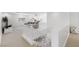 Open hallway with carpet flooring, white walls, staircase, and views into other rooms at 7360 Dolphine Crest Ave, Las Vegas, NV 89129