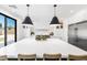 Spacious kitchen showcasing a large white island, custom cabinetry, and modern pendant lights at 7360 Dolphine Crest Ave, Las Vegas, NV 89129