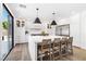 Elegant kitchen featuring a large island with seating, custom white cabinetry, and stainless steel appliances at 7360 Dolphine Crest Ave, Las Vegas, NV 89129