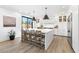 Bright kitchen featuring a large island with barstool seating, stainless steel appliances, and modern pendant lighting at 7360 Dolphine Crest Ave, Las Vegas, NV 89129