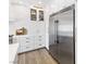 Close up of modern, gourmet kitchen showcasing stainless steel refrigerator and white cabinets at 7360 Dolphine Crest Ave, Las Vegas, NV 89129