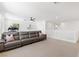 Spacious living room featuring a large sofa, neutral walls, and abundant natural light at 7360 Dolphine Crest Ave, Las Vegas, NV 89129