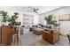 Comfortable living room showcasing a large sectional sofa, piano, natural light, and stylish décor at 7360 Dolphine Crest Ave, Las Vegas, NV 89129