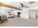 Open main bedroom with white walls, beam ceiling, sitting area, and carpeted floors at 7360 Dolphine Crest Ave, Las Vegas, NV 89129