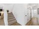 Bright staircase features white shiplap walls, carpeted steps, and leads to the upper level of the home at 7360 Dolphine Crest Ave, Las Vegas, NV 89129