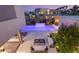Stunning backyard showcasing a modern pool with water features, a cozy seating area, and lush landscaping at 7385 Heron Canyon Ct, Las Vegas, NV 89117