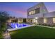 Gorgeous pool with water feature, outdoor kitchen, lounge seating, and modern home architecture at 7385 Heron Canyon Ct, Las Vegas, NV 89117