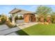 Outdoor view of the backyard featuring a modern sauna, outdoor grill, and manicured lawn at 7385 Heron Canyon Ct, Las Vegas, NV 89117