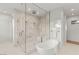 Modern bathroom showcasing a walk-in shower, soaking tub, and elegant tile work at 7385 Heron Canyon Ct, Las Vegas, NV 89117