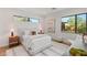 Well-lit bedroom with windows, light walls, wood floors, and tasteful decor creating a peaceful and inviting atmosphere at 7385 Heron Canyon Ct, Las Vegas, NV 89117