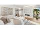 Bedroom featuring a fireplace, dry bar, and a large window overlooking the landscaped backyard and greenery at 7385 Heron Canyon Ct, Las Vegas, NV 89117